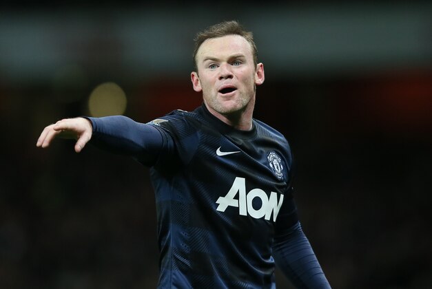 Manchester United's Wayne Rooney gestures to his teammates during their English Premier League soccer match between Arsenal and Manchester United at the Emirates stadium in London, Wednesday, Feb. 12, 2014. (AP Photo/Alastair Grant)
