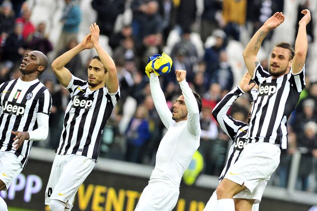 Juventus players celebrate at the end of a Serie A soccer match between Juventus and Chievo Verona at the Juventus stadium, in Turin, Italy, Sunday, Feb. 16, 2014. (AP Photo/Massimo Pinca)