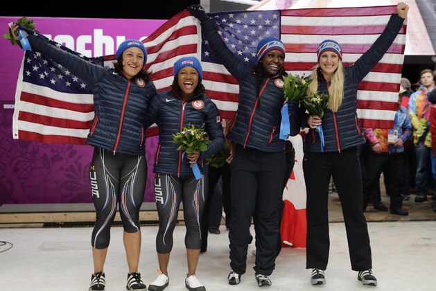 From left to right, silver medal winners from the United States Elana Meyers and Lauryn Williams, and bronze medal winners from the United States Aja Evans and Jamie Greubel pose for pictures after the women's bobsled competition at the 2014 Winter Olympics, Wednesday, Feb. 19, 2014, in Krasnaya Polyana, Russia. (AP Photo/Jae C. Hong)