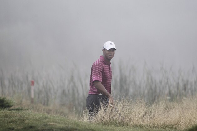 Tiger Woods walks to the sixth hole as some fog rolls in during a practice round for the PGA Championship golf tournament Tuesday, Aug. 10, 2010, at Whistling Straits in Haven, Wis. (AP Photo/Charlie Neibergall)