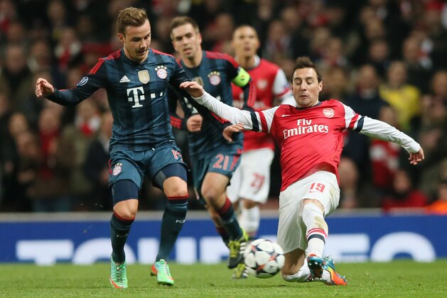 Arsenal's Santi Cazorla, right, and Bayern's Mario Goetze challenge for the ball during a Champions League, round of 16, first leg soccer match between Arsenal and Bayern Munich at the Emirates stadium in London, Wednesday, Feb. 19, 2014 .(AP Photo/Alastair Grant)