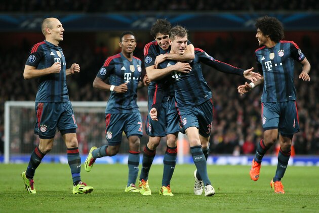 Munich's Toni Kroos, front celebrates his side's opening goal withArjen Robben, David Alaba, Javier Martinez and Dante, from left,  during a Champions League, round of 16, first leg soccer match between Arsenal and Bayern Munich at the Emirates stadium in London, Wednesday, Feb. 19, 2014 .(AP Photo/Alastair Grant)