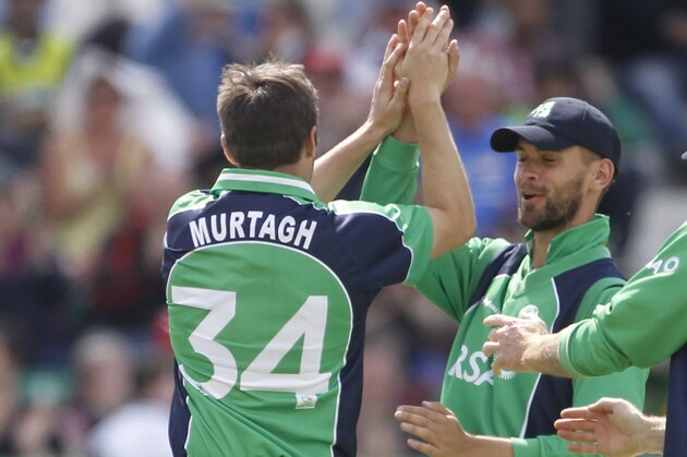 Ireland's Tim Murtagh, left, reacts with James Shannon, centre, and Trent Johnston, right, after Murtagh caught out Pakistan's Nasir Jamshaid during their One Day Cricket International at Clontarf Cricket Club, Dublin, Ireland, Sunday, May 26, 2013. (AP Photo/Peter Morrison)