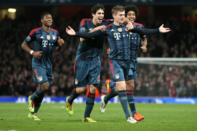 Munich's Toni Kroos, front celebrates his side's opening goal with David Alaba, Javier Martinez and Dante, from left,  during a Champions League, round of 16, first leg soccer match between Arsenal and Bayern Munich at the Emirates stadium in London, Wednesday, Feb. 19, 2014 .(AP Photo/Alastair Grant)