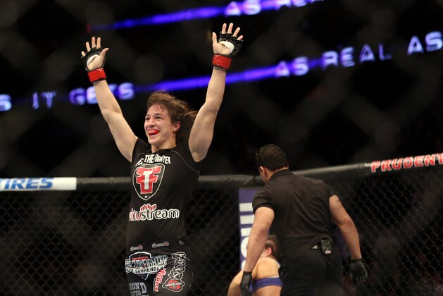 Sara McMann celebrates her win over Sheila Gaff after their UFC 159 Mixed Martial Arts bout in Newark, NJ, Saturday, April 27,2013.  McMann won via first round TKO. (AP Photo/Gregory Payan)