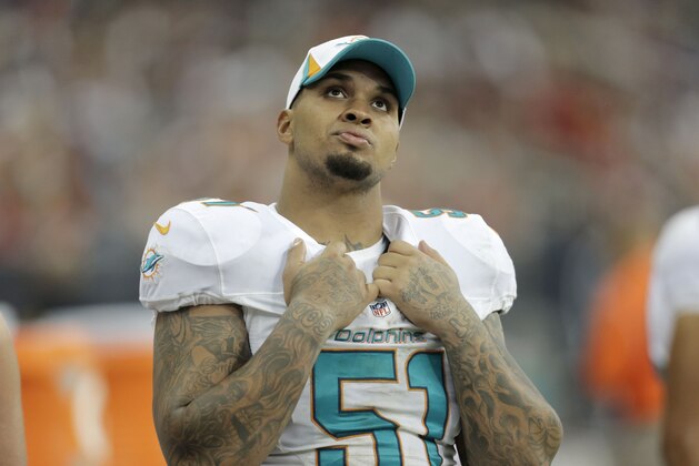 Miami Dolphins' Mike Pouncey watches from the sidelines during the second half of a preseason NFL football game against the Houston Texans Saturday, Aug. 17, 2013, in Houston. (AP Photo/Eric Gay)