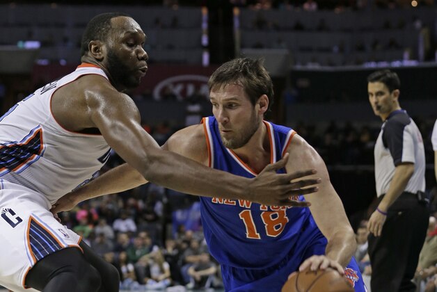 New York Knicks' Beno Udrih, right, drives past Charlotte Bobcats' Al Jefferson, left, during the second half of an NBA basketball game in Charlotte, N.C., Tuesday, Jan. 14, 2014. The Bobcats won 108-98. (AP Photo/Chuck Burton)