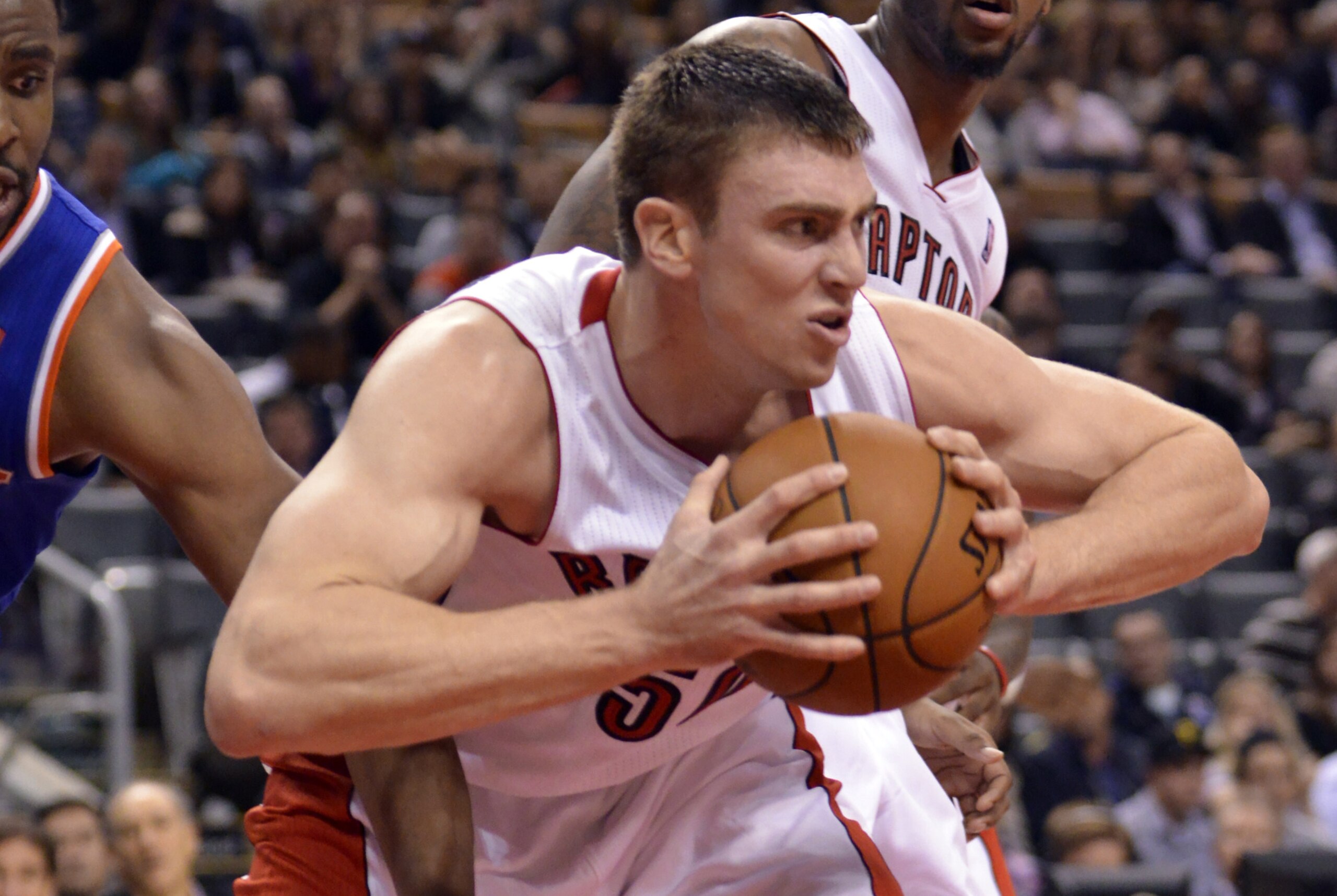 Oct 21, 2013; Toronto, Ontario, CAN; Toronto Raptors power forward Tyler Hansbrough (50) grabs a rebound in the first overtime period of a game against the New York Knicks at the Air Canada Centre. Toronto won the game in triple overtime123-120. Mandatory Credit: Mark Konezny-USA TODAY Sports