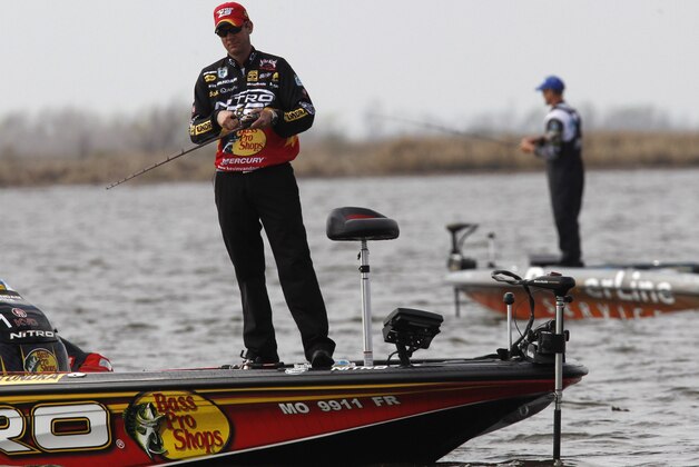 Current leader Kevin VanDam, of Kalamazoo, Mich., foreground, and Keith Combs, of Del Rio, Texas, compete during the Bassmaster Classic during the final round in Lake Cataouatche in Jefferson Parish, La., Sunday, Feb. 20, 2011. (AP Photo/Gerald Herbert)
