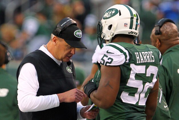 Dec 22, 2013; East Rutherford, NJ, USA; New York Jets head coach Rex Ryan speaks with inside linebacker David Harris (52) during the second half against the Cleveland Browns at MetLife Stadium.  The Jets defeated the Browns 24-13.  Mandatory Credit: Ed Mulholland-USA TODAY Sports