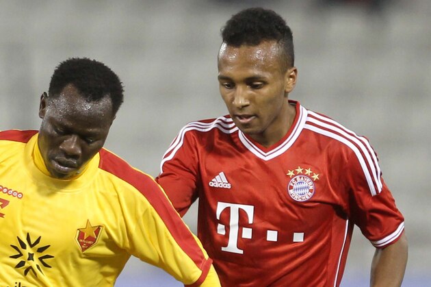 Bayern Munich's Julian Green, right, of Munich and Balla Jabir of Al-Merrikh, challenge for the ball,  during their friendly soccer match, at Al-Saad stadium in Doha Thursday, Jan. 9, 2014. (AP Photo/Osama Faisal)