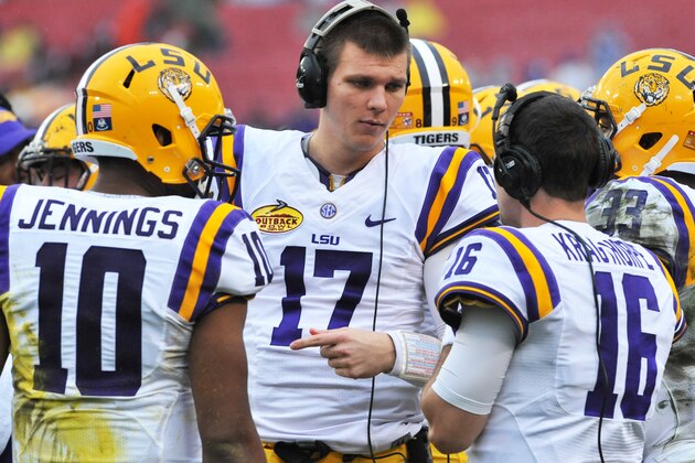 TAMPA, FL -  JANUARY 1:  Quarterbacks Anthony Jennings #10, Stephen Rivers #17 and  Brad Kragthorpe #16 of the LSU Tigers talk on the sidelines during play against the Iowa Hawkeyes January 1, 2014  in the Outback Bowl at Raymond James Stadium in Tampa, Florida.  (Photo by Al Messerschmidt/Getty Images)