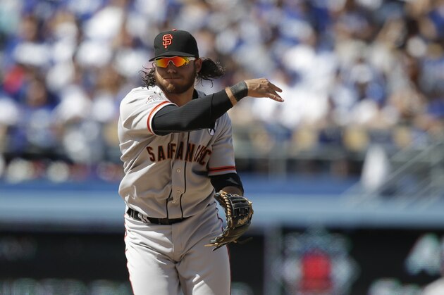 San Francisco Giants shortstop Brandon Crawford throws the ball during the eighth inning of a season-opening baseball game against the Los Angeles Dodgers in Los Angeles, Monday, April 1, 2013. (AP Photo/Jae C. Hong)