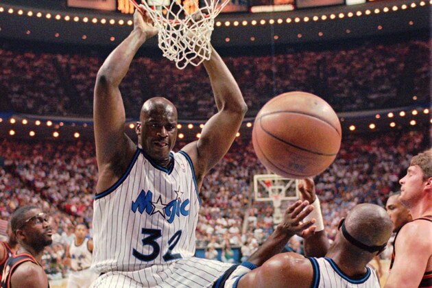 FILE -- Orlando Magic center Shaquille O'Neal (32) hangs onto the rim after a powerful slam dunk during the first quarter fo their Eastern Conference Semifinal game against the Atlanta Hawks May 8, 1996 in Orlando.  Defending on the play is Hawks Grant Long (43), left, Horace Grant (54) and Christian Laettner (32) , right. The NBA imposed a lockout Tuesday morning July 9, 1996 after contract talks with the players' union broke down, further delaying the opening of the biggest free agent market in league history. he move halted today's expected free-agent frenzy, with such superstars as O'Neal, Michael Jordan and Reggie Miller up for grabs. (AP Photo/Peter Cosgrove)