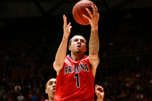 Feb 19, 2014; Salt Lake City, UT, USA; Arizona Wildcats guard Gabe York (1) gets past Utah Utes guard Brandon Taylor (11) and lays the ball up to the basket during the first half at Jon M. Huntsman Center. Mandatory Credit: Chris Nicoll-USA TODAY Sports