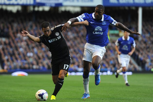 LIVERPOOL, ENGLAND - SEPTEMBER 14:  Eden Hazard of Chelsea competes with Sylvain Distin of Everton during the Barclays Premier League match between Everton and Chelsea at Goodison Park on September 14, 2013 in Liverpool, England.  (Photo by Chris Brunskill/Getty Images)
