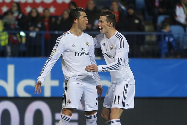 Real's Cristiano Ronaldo, left, celebrates his goal with teammate Gareth Bale during a semifinal, 2nd leg, Copa del Rey soccer match between Atletico de Madrid and Real Madrid at the Vicente Calderon stadium in Madrid, Spain, Tuesday Feb. 11, 2014. (AP Photo/Andres Kudacki)