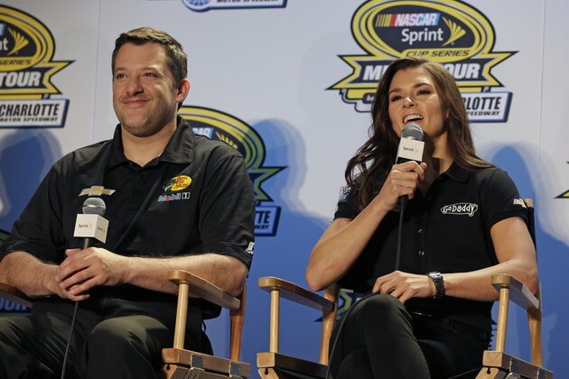 Danica Patrick, right, jokes with team co-owner Tony Stewart, left, during news conference at the NASCAR Sprint Cup auto racing Media Tour in Charlotte, N.C., Monday, Jan. 27, 2014. (AP Photo/Chuck Burton)