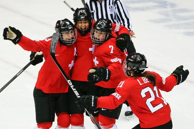 Jessica Lutz of Switzerland (17), 2nd left, celebrates with her teammates after scoring on Sweden during the third period of the women's bronze medal ice hockey game at the 2014 Winter Olympics, Thursday, Feb. 20, 2014, in Sochi, Russia. (AP Photo/Julio Cortez)