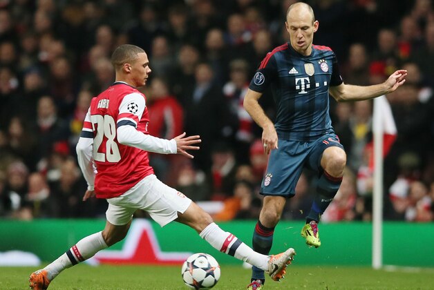 Arsenal's Kieran Gibbs, left, and Bayern's Bayern's Arjen Robben challenge for the ball during a Champions League, round of 16, first leg soccer match between Arsenal and Bayern Munich at the Emirates stadium in London, Wednesday, Feb. 19, 2014 .(AP Photo/Alastair Grant)