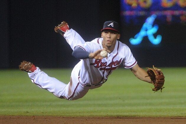 Atlanta Braves shortstop Andrelton Simmons throws the ground ball of New York Mets' Kirk Nieuwenhuis to Dan Uggla at second base to force out John Buck during the ninth inning of a baseball game, Monday, June 17, 2013, in Atlanta. (AP Photo/John Amis)