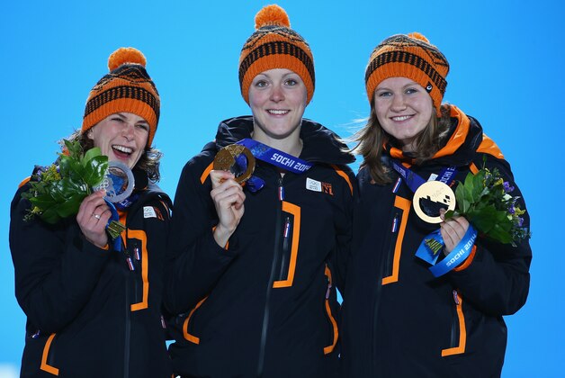 SOCHI, RUSSIA - FEBRUARY 17:  (L-R) Silver medalist Ireen Wust of the Netherlands, gold medalist Jorien ter Mors of the Netherlands and bronze medalist Lotte van Beek of the Netherlands celebrate on the podium during the flower ceremony on day ten of the Sochi 2014 Winter Olympics at the Medals Plaza on February 17, 2014 in Sochi, Russia.  (Photo by Streeter Lecka/Getty Images)