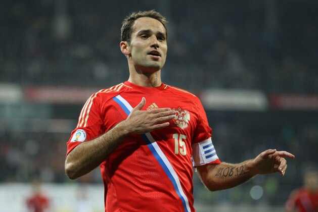 Russia's Roman Shirokov celebrates scoring against Azerbaijan during a World Cup Group F qualifying soccer match between Russia and Azerbaijan in Baku, Azerbaijan, Tuesday, Oct. 15, 2013. Russia qualified for the World Cup for the first time in 12 years by drawing 1-1 with 10-man Azerbaijan on Tuesday.  (AP Photo/Alexander Mysyakin)