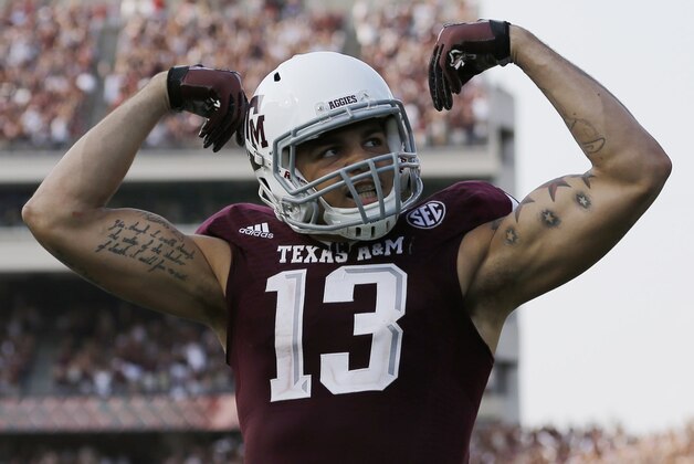 Texas A&M wide receiver Mike Evans (13) celebrates his 95-yard touchdown against Alabama during the fourth quarter of an NCAA college football game Saturday, Sept. 14, 2013, in College Station, Texas. (AP Photo/David J. Phillip)