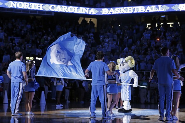 North Carolina's mascot waves a flag prior to an NCAA college basketball game against UNC Greensboro in Chapel Hill, N.C., Saturday, Dec. 7, 2013. (AP Photo/Gerry Broome)