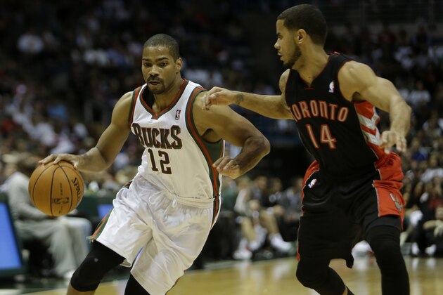 MILWAUKEE, WI - NOVEMBER 2: Gary Neal #12 of the Milwaukee Bucks dribbles the basketball with D.J. Augustin #14 of the Toronto Raptors defending in the second half of play at Bradley Center on November 2, 2013 in Milwaukee, Wisconsin. NOTE TO USER: User expressly acknowledges and agrees that, by downloading and or using this photograph, User is consenting to the terms and conditions of the Getty Images License Agreement. (Photo by Mike McGinnis/Getty Images)