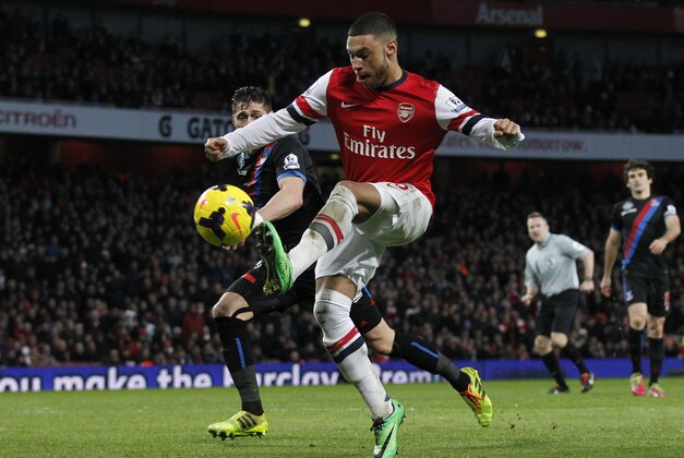Arsenal's Alex Oxlade-Chamberlain, right, scores against Crystal Palace during their English Premier League soccer match at Emirates Stadium in London, Sunday, Feb. 2, 2014. (AP Photo/Sang Tan)