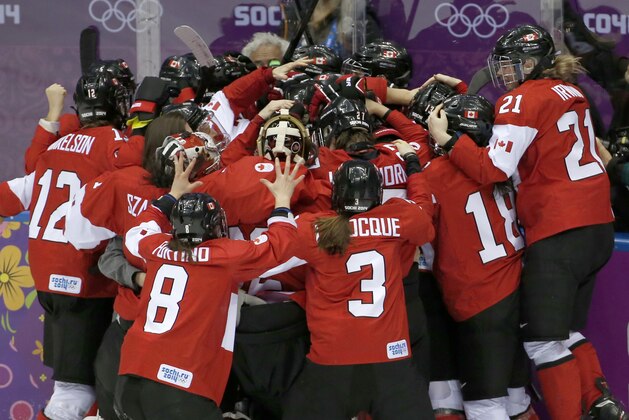 Team Canada celebrates their 3-2 victory over the United States in the women's gold medal ice hockey game at the 2014 Winter Olympics, Thursday, Feb. 20, 2014, in Sochi, Russia. (AP Photo/Petr David Josek)