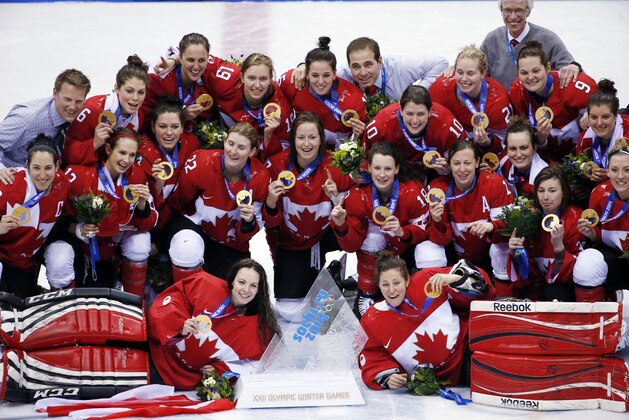Members of Team Canada pose for a photo with their gold medals after the awards ceremony for the women's ice hockey tournament at the 2014 Winter Olympics, Friday, Feb. 21, 2014, in Sochi, Russia. (AP Photo/Petr David Josek)