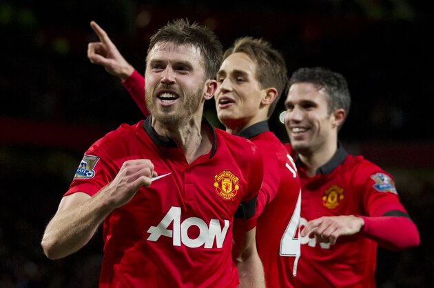 Manchester United's Michael Carrick, left, celebrates with teammates after scoring against Fulham during their English Premier League soccer match at Old Trafford Stadium, Manchester, England, Sunday Feb. 9, 2014. (AP Photo/Jon Super)
