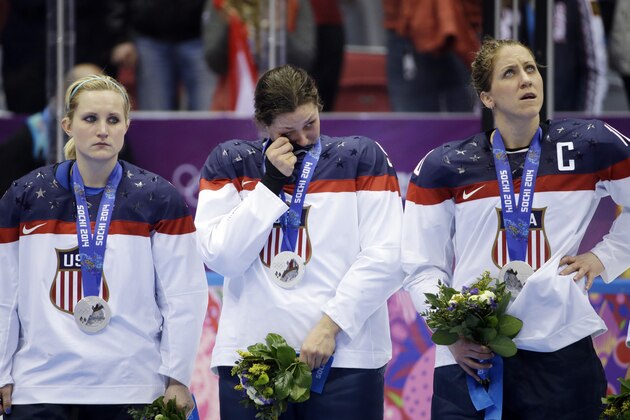 USA players react after losing the gold medal women's ice hockey game to Canada 3-2 in overtime at the 2014 Winter Olympics, Wednesday, Feb. 19, 2014, in Sochi, Russia. (AP Photo/David Goldman)