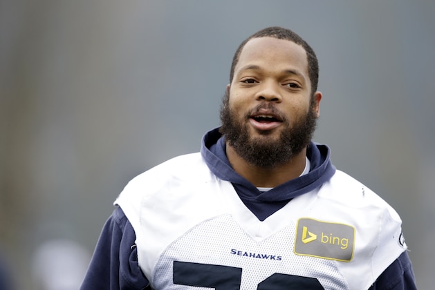 Seattle Seahawks' Michael Bennett walks on the field at an NFL football practice Thursday, Jan. 16, 2014, in Renton, Wash. The Seahawks play the San Francisco 49ers Sunday in the NFC championship game. (AP Photo/Elaine Thompson)