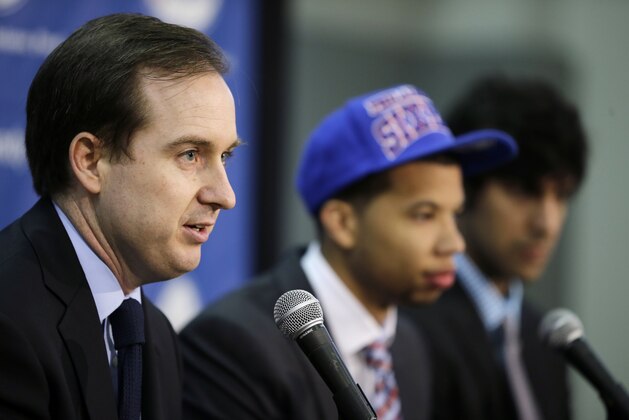 Philadelphia 76ers general manager Sam Hinkie, left, and newly-drafted players Michael Carter-Williams, center, and Arsalan Kazemi, of Iran, speak during a news conference at the team's NBA basketball practice facility, Friday, June 28, 2013, in Philadelphia. (AP Photo/Matt Slocum)
