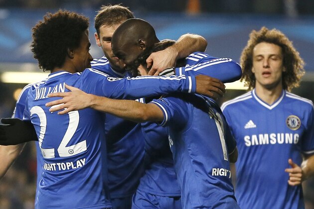 Chelsea's players celebrate after Demba Ba, centre, scores the opening goal during the Champions League Group E soccer match between Chelsea and Steaua Bucharest at Stamford Bridge Stadium  in London Wednesday, Dec. 11, 2013. (AP Photo/Kirsty Wigglesworth)