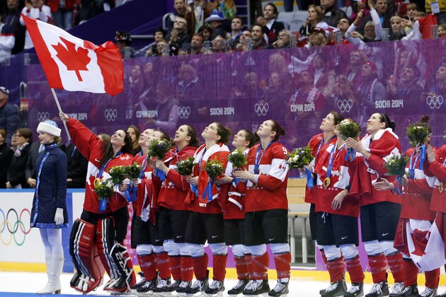 Team Canada sings the Canadian national anthem after receiving their gold medals after beating the USA 3-2 in overtime of the women's gold medal ice hockey game at the 2014 Winter Olympics, Friday, Feb. 21, 2014, in Sochi, Russia. (AP Photo/Mark Humphrey)