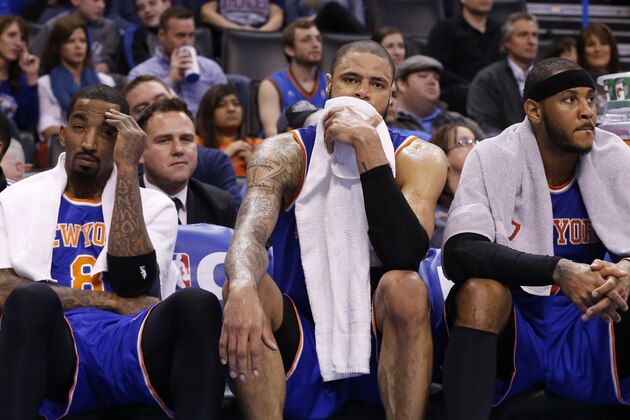 New York Knicks guard J.R. Smith, center Tyson Chandler, and forward Carmelo Anthony sit on the bench late in the fourth quarter of an NBA basketball game against the Oklahoma City Thunder, Sunday, Feb. 9, 2014, in Oklahoma City. Oklahoma City won 112-100. (AP Photo/Sue Ogrocki)