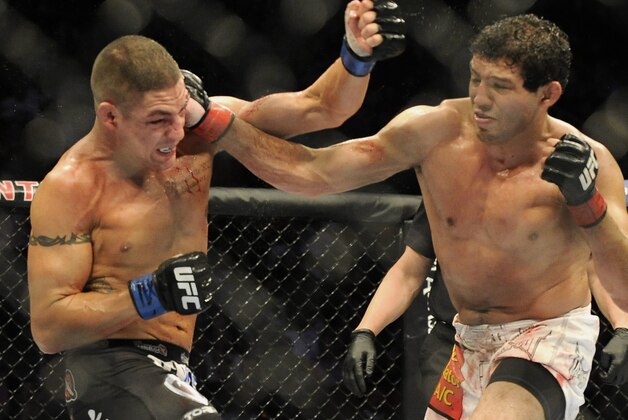 Gilbert Melendez, right, and Diego Sanchez fight in the second round of a UFC lightweight bout in Houston, Saturday, Oct. 19, 2013. Menendez won in a unanimous decision. (AP Photo/Pat Sullivan)