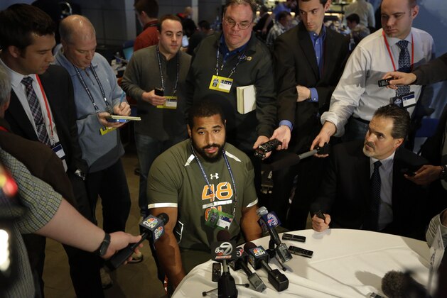 Penn State offensive lineman John Urschel answers a question during a news conference at the NFL football scouting combine in Indianapolis, Thursday, Feb. 20, 2014. (AP Photo/Michael Conroy)