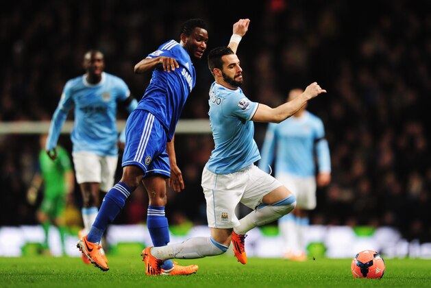 MANCHESTER, ENGLAND - FEBRUARY 15:  Alvaro Negredo (R) of Manchester City is tackled by Jon Obi Mikel (L) of Chelsea during the FA Cup Fifth Round match between Manchester City and Chelsea at the Etihad Stadium on February 15, 2014 in Manchester, England.  (Photo by Shaun Botterill/Getty Images)
