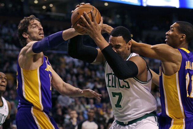 Los Angeles Lakers center Pau Gasol, front left, and forward Wesley Johnson, right, pressure Boston Celtics forward Jared Sullinger (7) on a rebound during the first quarter of an NBA basketball game in Boston, Friday, Jan. 17, 2014. (AP Photo/Charles Krupa)
