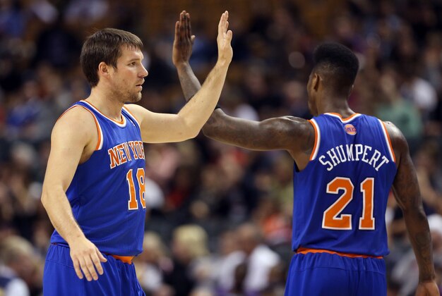 Oct 11, 2013; Toronto, Ontario, CAN; New York Knicks point guard Beno Udrih (18) celebrates a scoring run with guard Iman Shumpert (21) against the Toronto Raptors at Air Canada Centre. The Raptors beat the Knicks 100-91. Mandatory Credit: Tom Szczerbowski-USA TODAY Sports