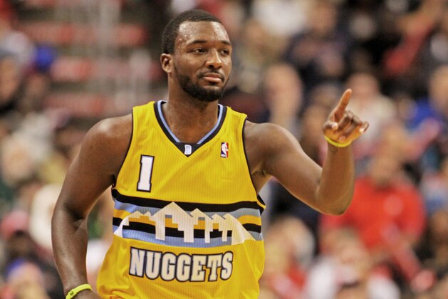 Denver Nuggets'  Jordan Hamilton (1) points to his bench after he scored against the Philadelphia 76ers in the second half of an NBA basketball game Saturday Dec. 7, 2013, in Philadelphia.  (AP Photo/H. Rumph Jr)