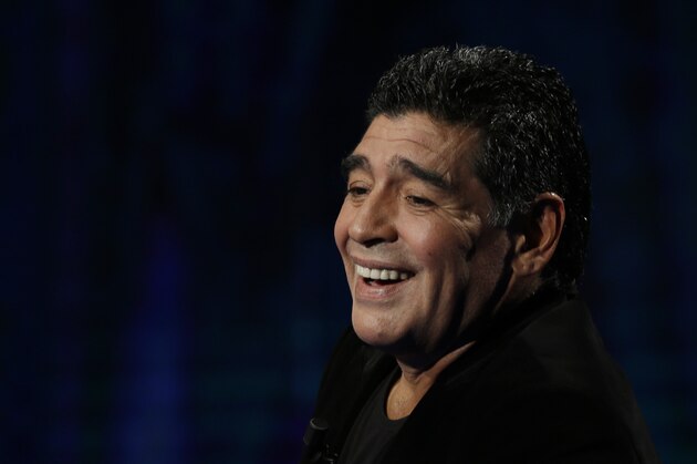Argentine's former soccer Diego Armando Maradona watches as he attends the Italian TV state program 'Che tempo che fa', in Milan, Italy, Sunday, Oct. 20, 2013. Italy's tax collection agency says it has formally notified Diego Maradona that it will begin procedures to freeze his assets in Italy to pay off his tax debt of $53 million. Equitalia confirmed news reports Friday saying its agents had served Maradona with the notification in his Milan hotel room, and that he signed the documentation. The Argentine great is in Italy to promote a video series on his life and watched his former club Napoli play Roma on Friday. (AP Photo/Luca Bruno)