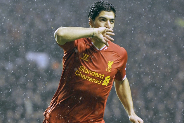 Liverpool's Luis Suarez celebrates after he scores the fourth goal of the game for his side during their English Premier League soccer match against Everton at Anfield in Liverpool, England, Tuesday Jan. 28, 2014. (AP Photo/Clint Hughes)