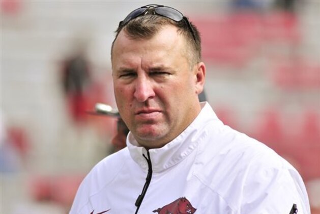 File- This Oct. 12, 2013 file photo shows Arkansas coach Bret Bielema leaving the field after an NCAA college football game against South Carolina in Fayetteville, Ark.  Bielema engaged in some back-and-fort with Auburn coach Gus Malzahn during the summer about the pace of college offenses. The two will finally meet on the field this week when the surging Tigers visit the Razorbacks, losers of five straight who are coming off a bye. (AP Photo/April L. Brown, File)