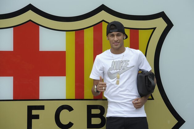 FILE - In this June 3, 2013 file photo, FC Barcelona's then new signing Neymar gestures upon his arrival at the club's office at the Camp Nou stadium in Barcelona, Spain. A Spanish court has charged Spanish league champion Barcelona with tax fraud of  euro 9.1 million ($12.5 million) over the transfer of Brazil forward Neymar. Judge Pablo Ruz said in his decision, released on Thursday, Feb. 20, 2014 there was enough evidence to merit charges over Neymar's 57 million-euro (then $77 million) move from Santos last summer. Thursday's decision comes a day after public prosecutor Jose Perals charged Barcelona with fabricating simulated contracts and using